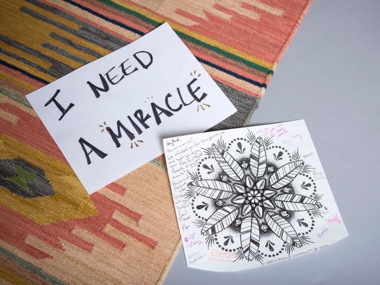 A handwritten sign reading I NEED A MIRACLE rests beside a mandala drawing, surrounded by colorful hippie notes on a boho-patterned rug. Soul Flower Blog: Hippie Style & Kind Living