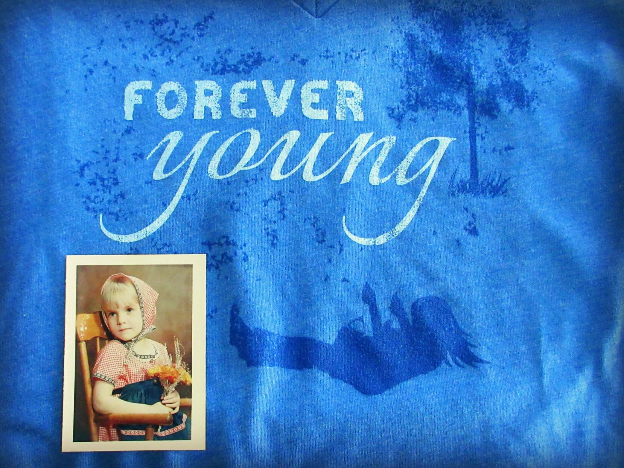 A blue shirt with FOREVER young printed above a silhouette of a girl on a swing, next to an old photo of a child holding wheat—capturing the essence of natural, mindful living. Soul Flower Blog: Hippie Style & Kind Living