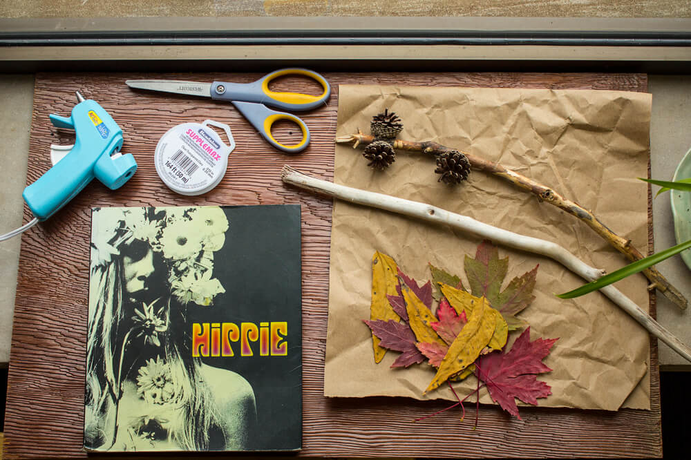 A hot glue gun, scissors, string, twigs, leaves, pine cones, brown paper, and a funky Hippie book create a boho vibe on a sunlit table by the window. Soul Flower Blog: Hippie Style & Kind Living