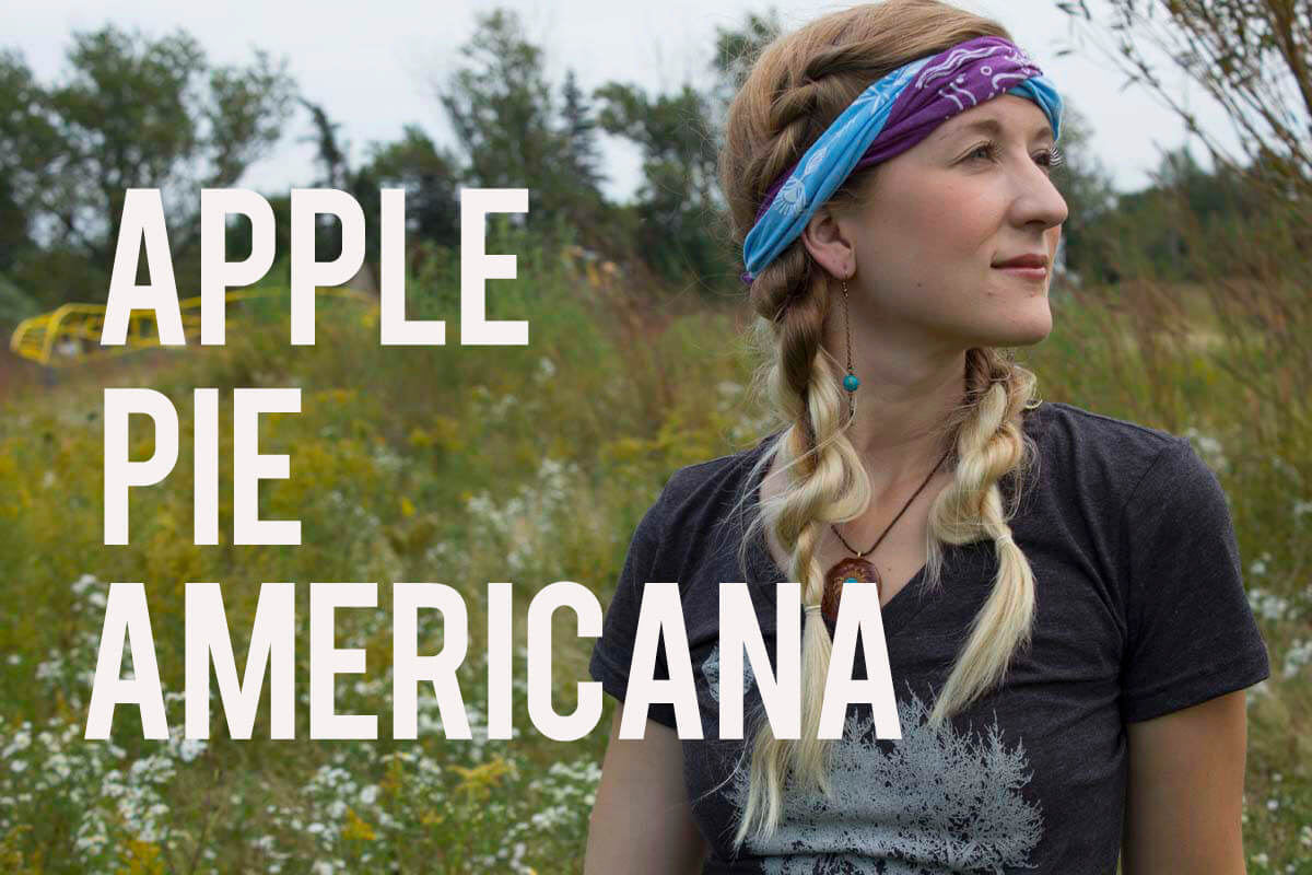 A woman with blonde braids and a purple headband stands in a field, looking to the side. Large text over the image reads APPLE PIE AMERICANA PLAYLIST. Soul Flower Blog: Hippie Style & Kind Living