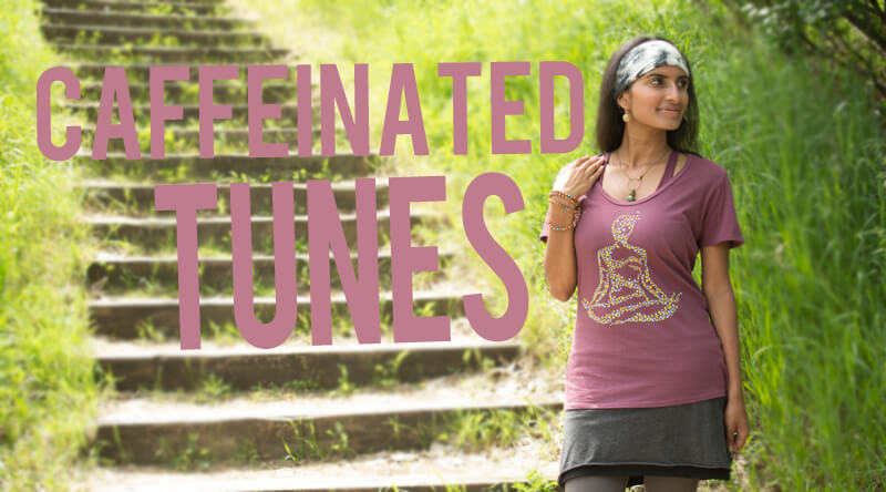 A woman stands on a grassy path near wooden steps, wearing a purple shirt with a yoga design. Large text reads Caffeinated Tunes, capturing the energetic vibe of the moment. Soul Flower Blog: Hippie Style & Kind Living