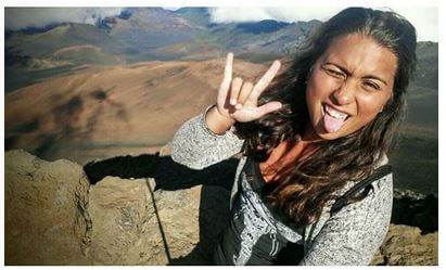 A woman stands on a rocky mountaintop, sticking out her tongue and making a rock on hand gesture while taking a selfie—Fan Photos! August-September 2015. Soul Flower Blog: Hippie Style & Kind Living