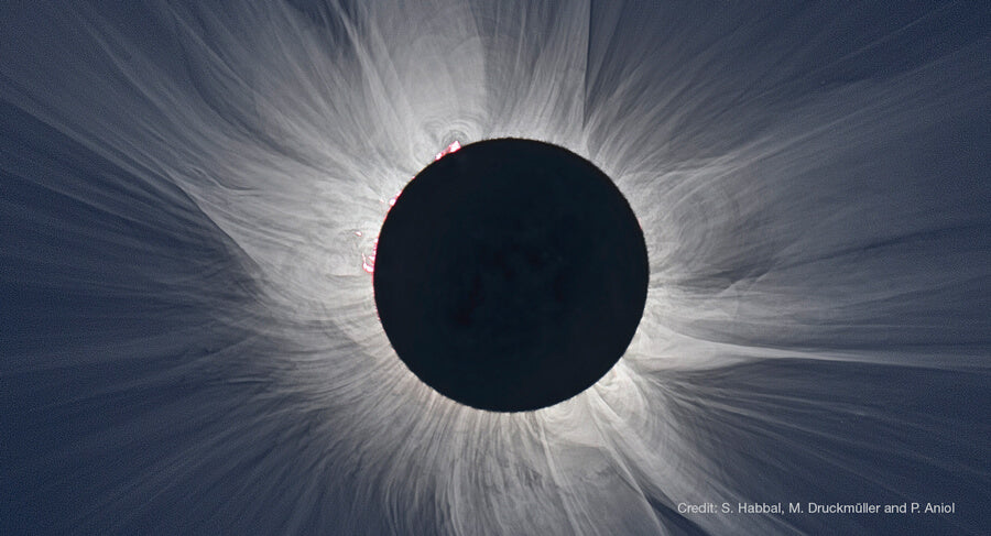 A total solar eclipse shows the Moon blocking the Sun, revealing the Sun’s outer corona and some funky red solar prominences glowing around the Moon’s edge. Soul Flower Blog: Hippie Style & Kind Living