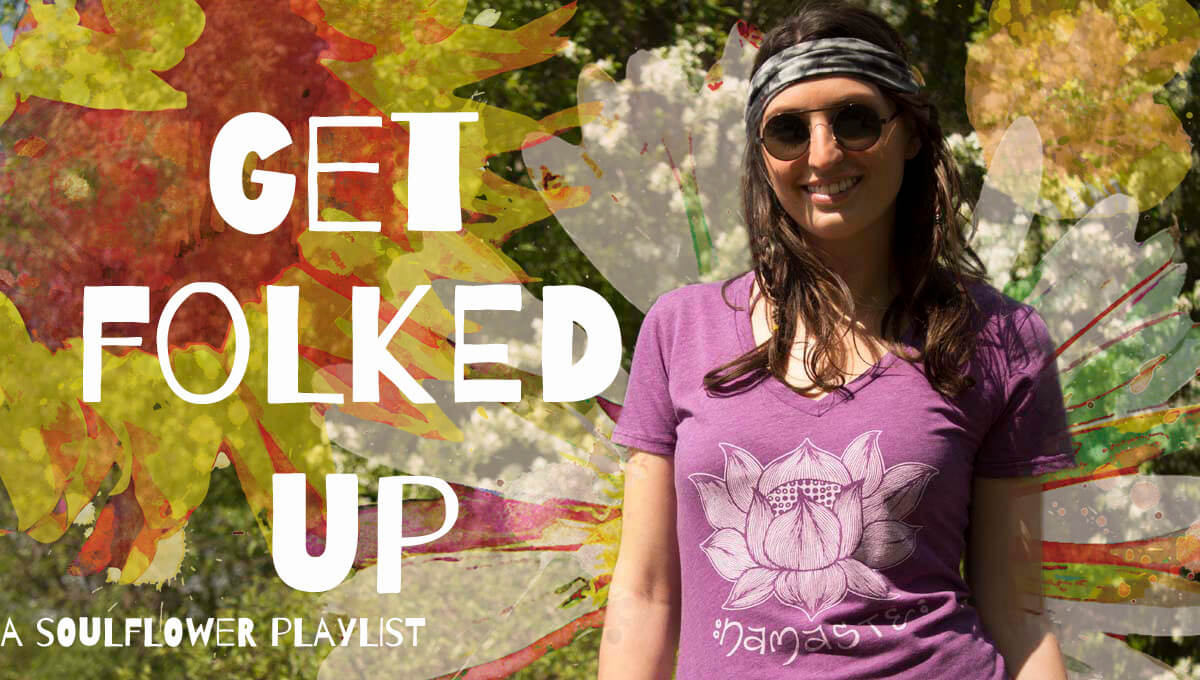 Smiling woman in boho sunglasses and a headband stands outdoors in front of colorful floral art with the text Get Folked Up—A Soulflower Playlist. Soul Flower Blog: Hippie Style & Kind Living