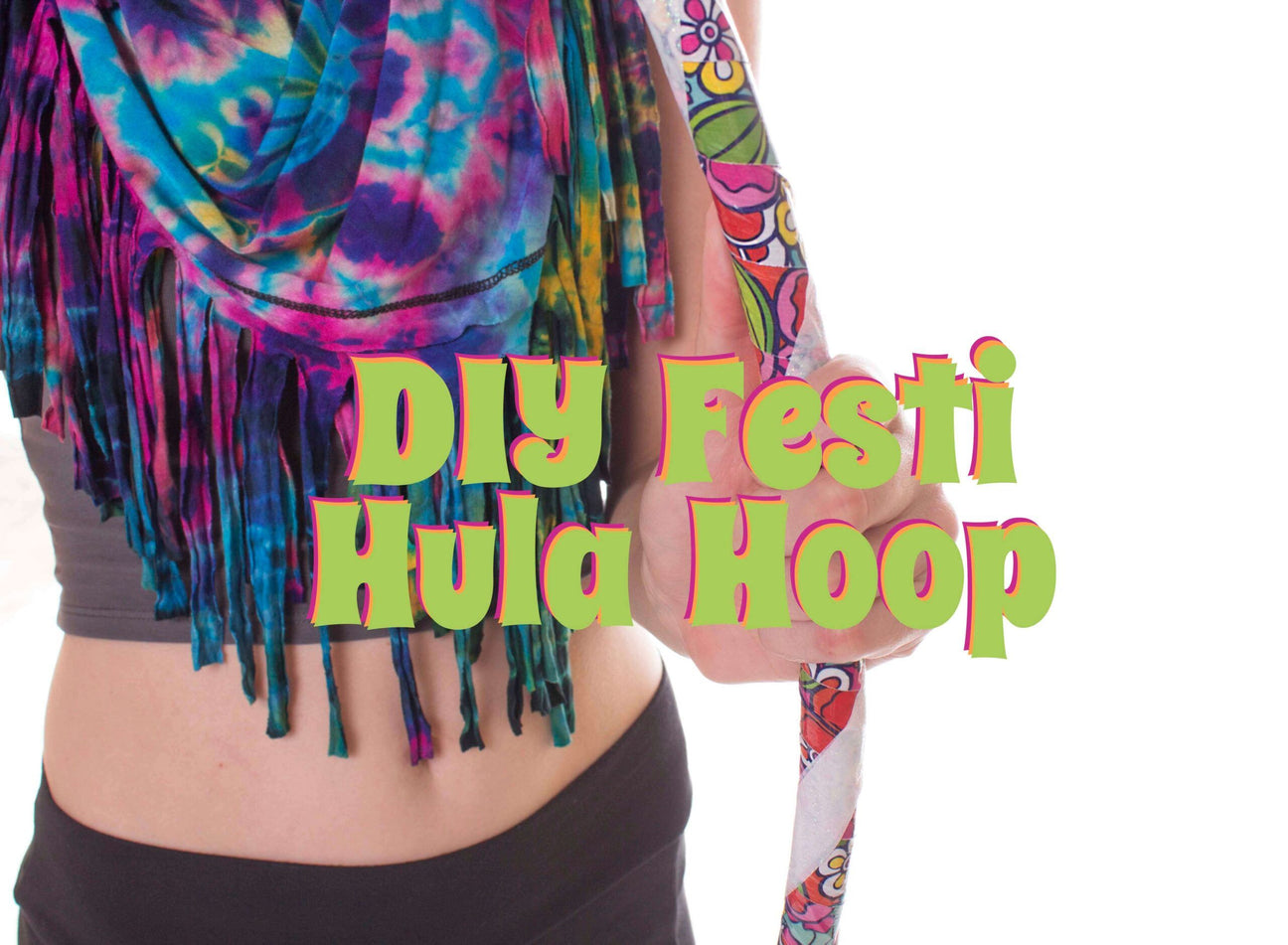 Person wearing a tie-dye scarf and black shorts holds a colorful hula hoop. Text over image reads: DIY Festi Make a Hula Hoop. Soul Flower Blog: Hippie Style & Kind Living