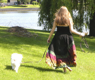 mudmee dress in the grass with white puppy