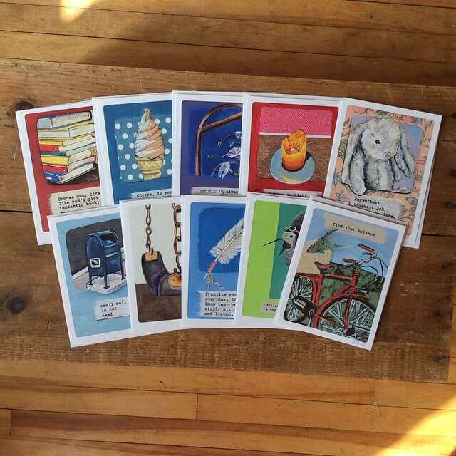 Ten illustrated cards featuring various objects and animals—like books, ice cream, a candle, a rabbit, and a bicycle—are displayed on a wooden floor, capturing an eco-inspired vibe with boho charm. Soul Flower Blog: