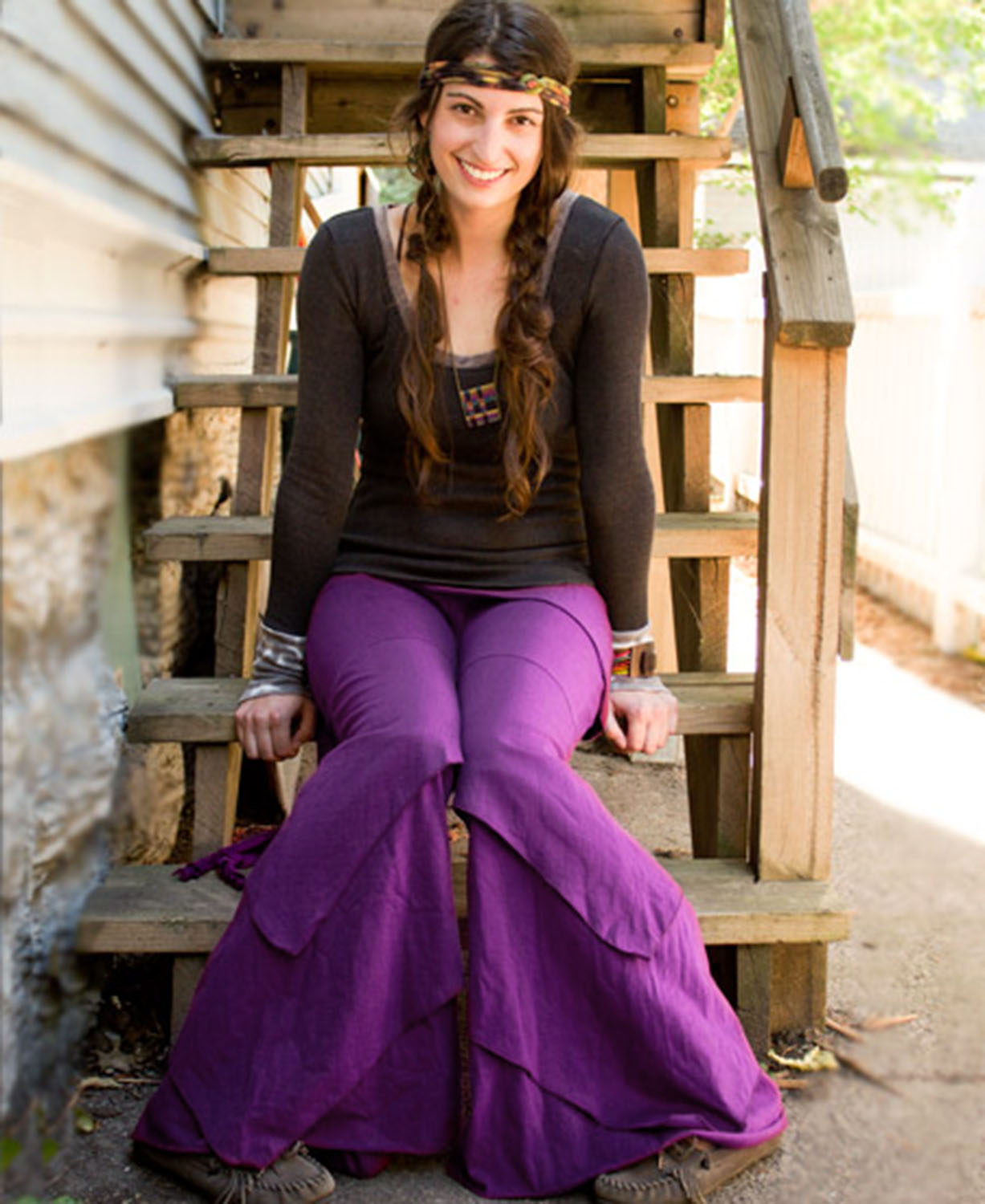 Woman wearing purple Waves of Freedom layered wide leg pants outdoors