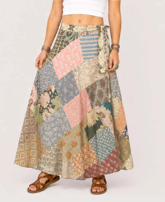 Waist down view of colorful patchwork wrap skirt with adjustable side tie