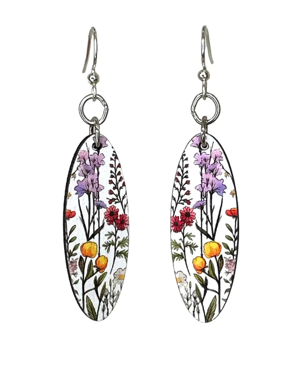 A pair of dangling earrings with oval white enamel pendants featuring a colorful botanical illustration of purple flowers, red blossoms, yellow-orange berries, and green stems, suspended from silver fishhook wires.