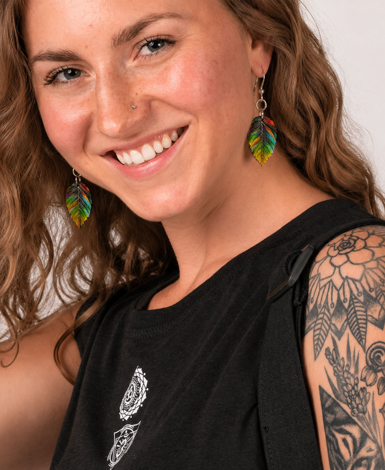 Color Me Kind Leaf Earringson white background on model with brown wavy hair