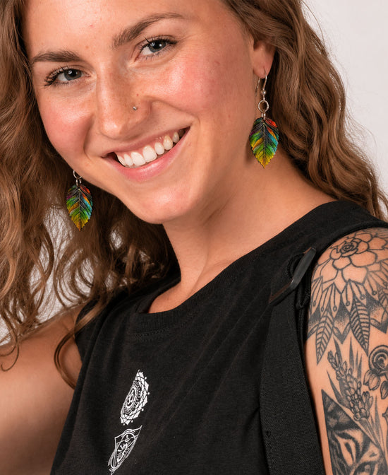 Color Me Kind Leaf Earringson white background on model with brown wavy hair