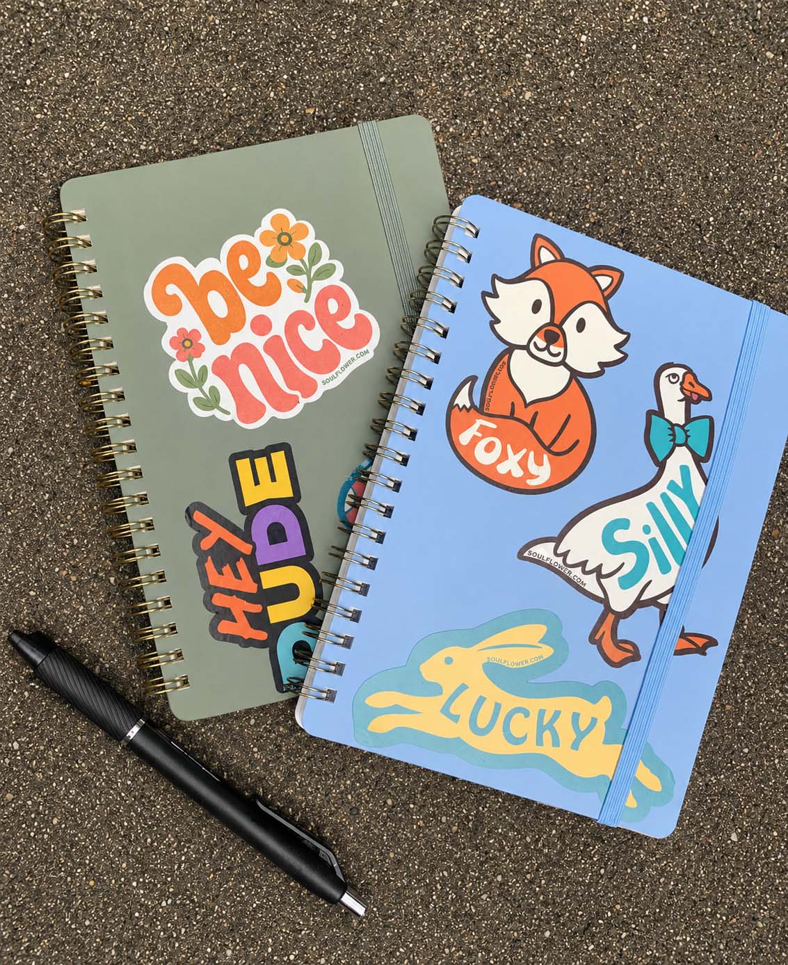 Stack of two spiral bound journals with Soul Flower Stickers Foxy, Silly, Lucky, Be Nice, and Hey Dude